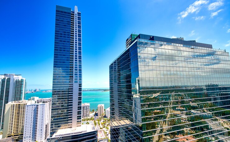 A breathtaking view of the ocean and urban buildings from a high-rise in Miami, capturing the city's charm and landscape.