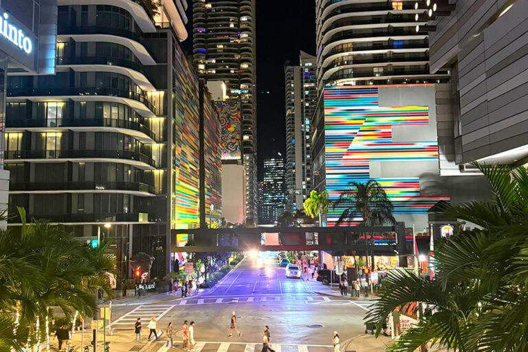 Vibrant city scene in Brickell, Miami Lakes, featuring towering buildings and many people enjoying the street.