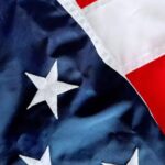 A close-up view of the United States flag, featuring embroidered stars and red and white stripes, symbolizing professionalism and trust in Miami, Florida website design services.